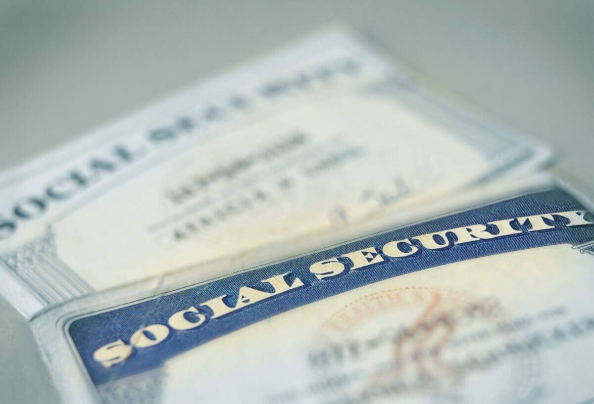 2 social security cards laying on a table