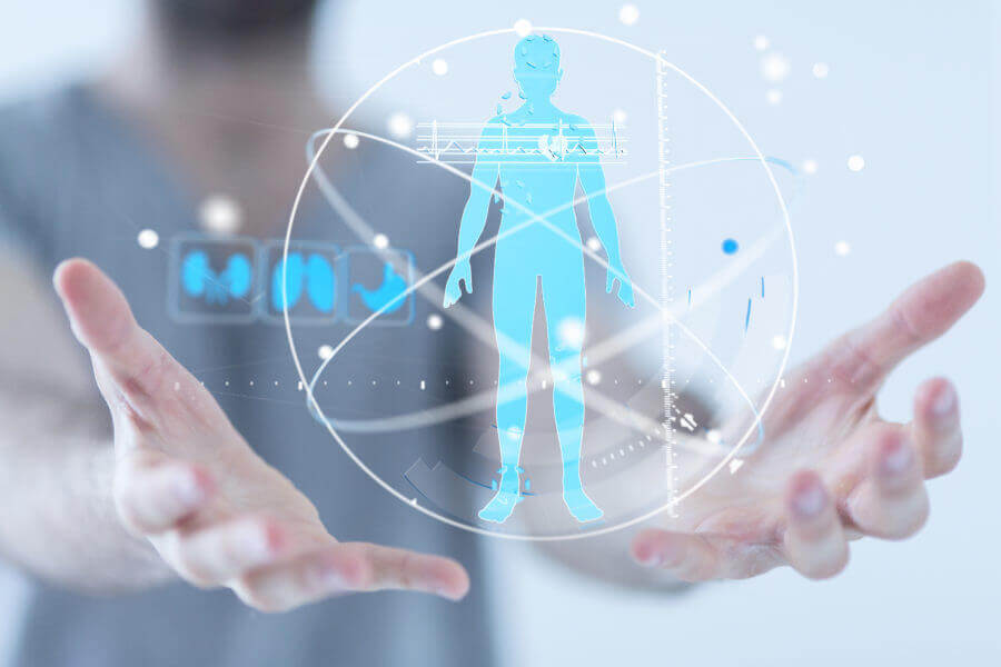 A man in scrubs holding a digital rendering of a human body