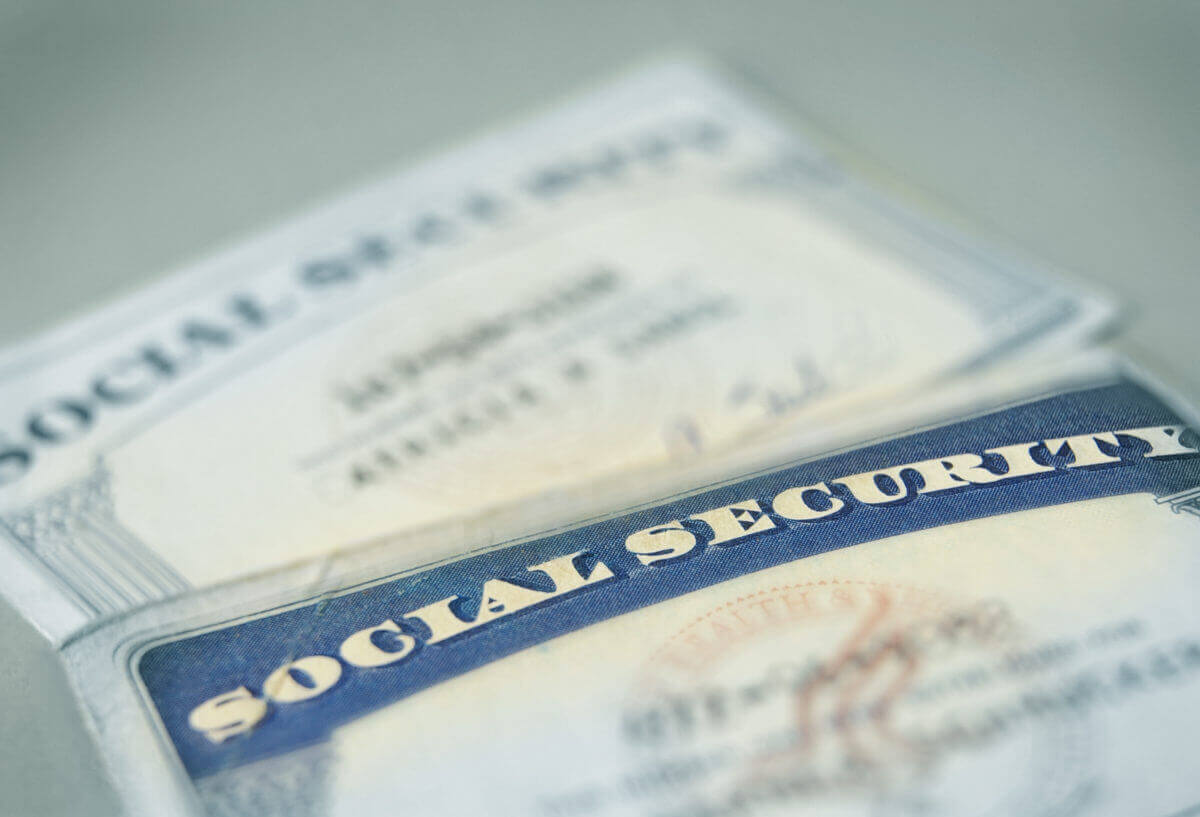2 social security cards laying on a table